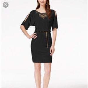 Beautiful elegant dress with gold metal designs.